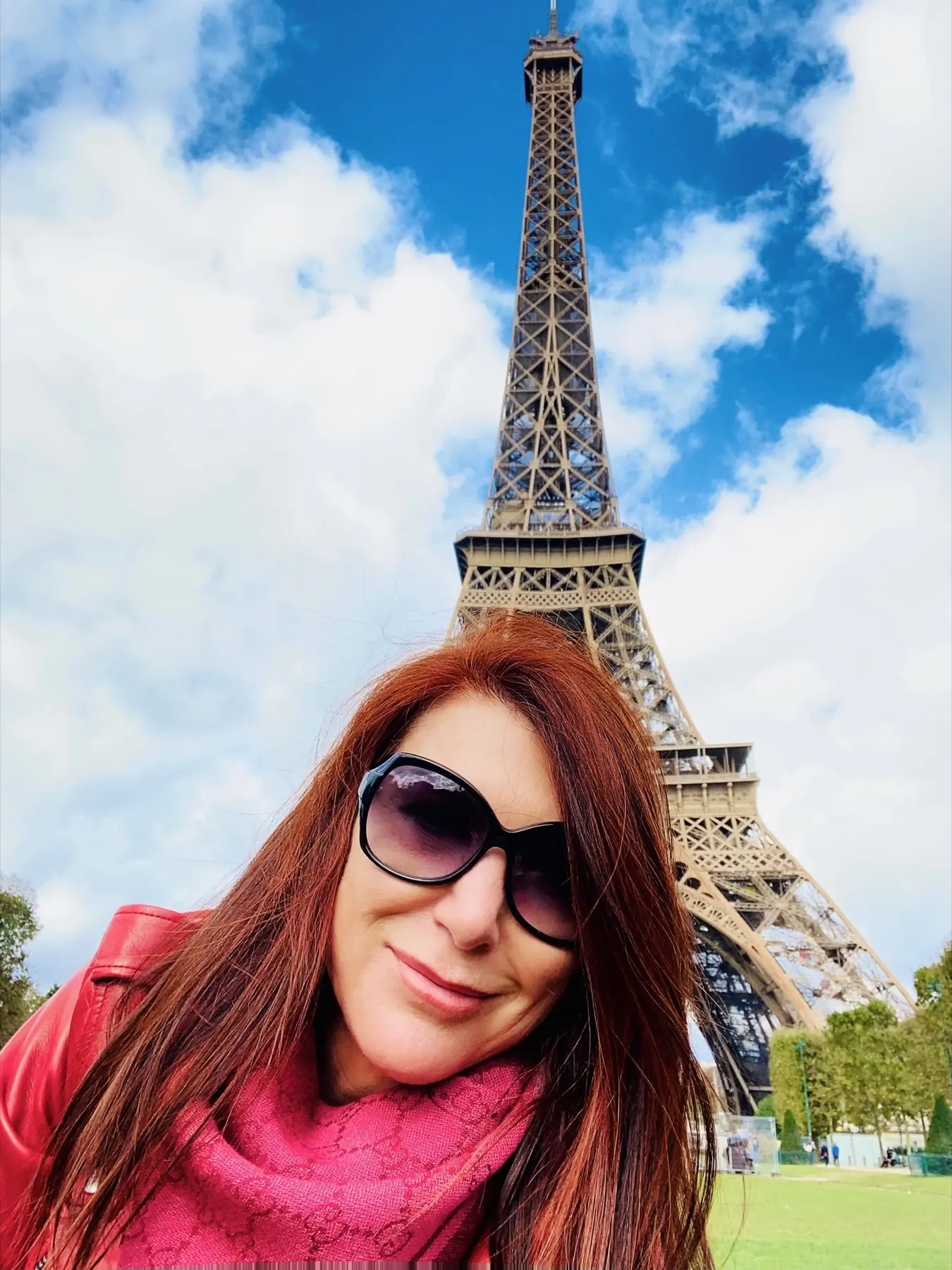 Monica smiling in front of the Eiffel Tower in Paris